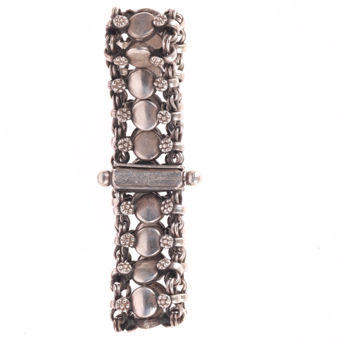 1394 - RICHARG AABOE - a Danish sterling silver flowerhead panel bracelet, 18cm, 65.2g