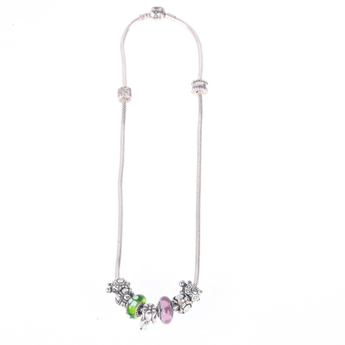 1409 - PANDORA - a sterling silver snake link charm necklace, with 7 charms and 2 spacer charms, 41cm, 54.4... 