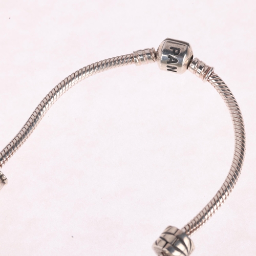 1409 - PANDORA - a sterling silver snake link charm necklace, with 7 charms and 2 spacer charms, 41cm, 54.4... 