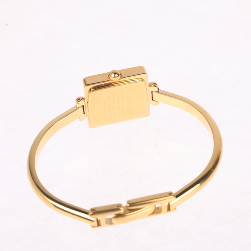 1027 - GUCCI - a lady's gold plated stainless steel 1900L quartz bangle watch, champagne dial with leaf han... 