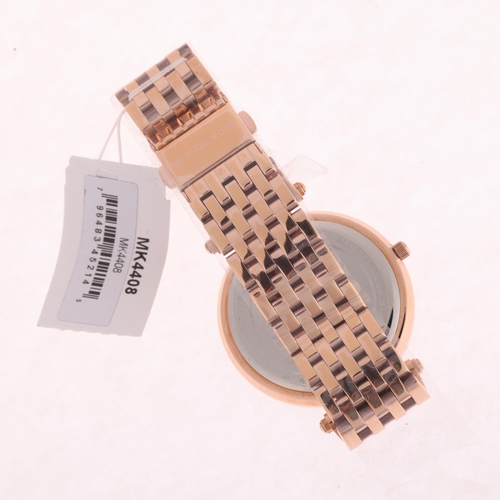 1033 - MICHAEL KORS - an unworn lady's rose gold plated stainless steel Darci quartz bracelet watch, ref. M... 