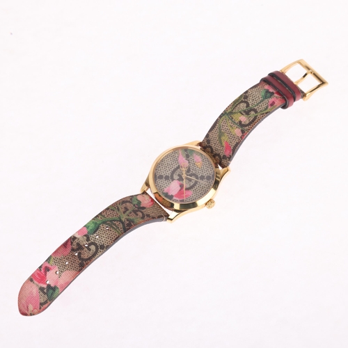 1034 - GUCCI - a lady's gold plated stainless steel G-Timeless 'Pink Blooms' quartz wristwatch, ref. 126.4,... 