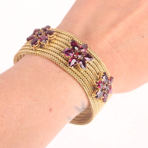 1103 - A 9ct gold garnet triple flowerhead mesh bracelet, set with round and pear-cut garnets, apparently u... 