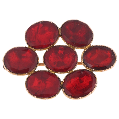 1109 - A Georgian flat-top red paste cluster mourning brooch, circa 1820, cut-down collet set with foil-bac... 