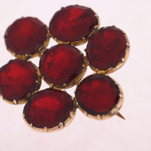 1109 - A Georgian flat-top red paste cluster mourning brooch, circa 1820, cut-down collet set with foil-bac... 