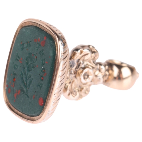 1111 - An Antique Victorian bloodstone 'Forget-Me-Not' seal fob, the panel intaglio carved with wording and... 