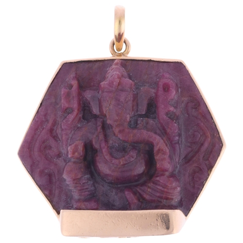 1128 - A large Eastern 14ct gold ruby Hindu God Ganesha pendant, set with carved and polished hexagonal rub... 