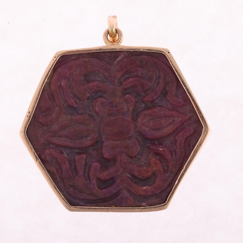 1128 - A large Eastern 14ct gold ruby Hindu God Ganesha pendant, set with carved and polished hexagonal rub... 