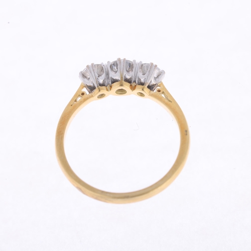 1138 - An 18ct gold three stone diamond ring, claw set with modern round brilliant-cut diamonds, total diam... 