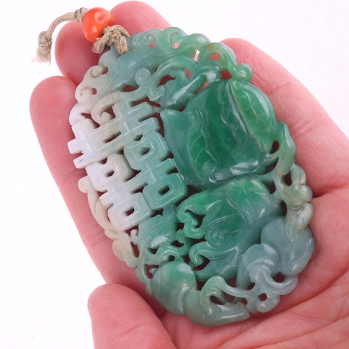 1142 - A Chinese carved jade 'Double Happiness' amulet pendant, carved and pierced depicting peach and blos... 