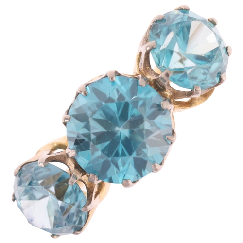 1158 - An 18ct gold three stone blue zircon ring, claw set with round-cut zircons, setting height 10.5mm, s... 