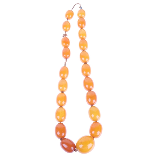 1168 - A single-row graduated amber bead necklace, beads measure: 29.0 - 17.5mm, 50cm, 82g