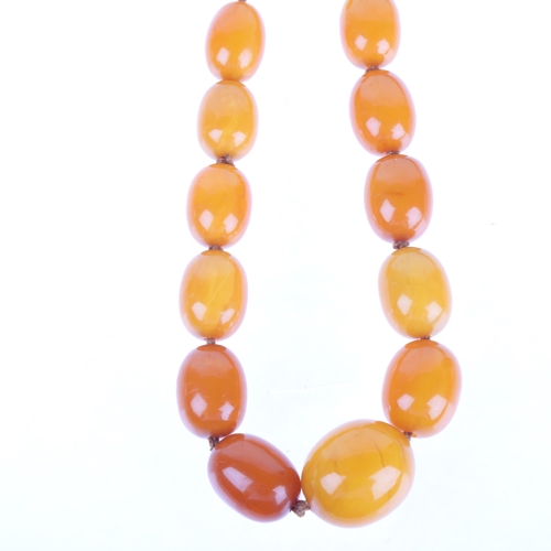 1168 - A single-row graduated amber bead necklace, beads measure: 29.0 - 17.5mm, 50cm, 82g