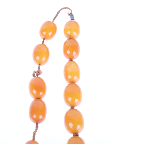 1168 - A single-row graduated amber bead necklace, beads measure: 29.0 - 17.5mm, 50cm, 82g