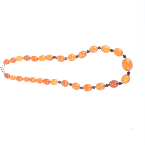 1169 - A single-row graduated amber bead necklace, beads measure 20.7 - 12.4mm, 50cm, 41.6g