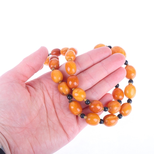 1169 - A single-row graduated amber bead necklace, beads measure 20.7 - 12.4mm, 50cm, 41.6g