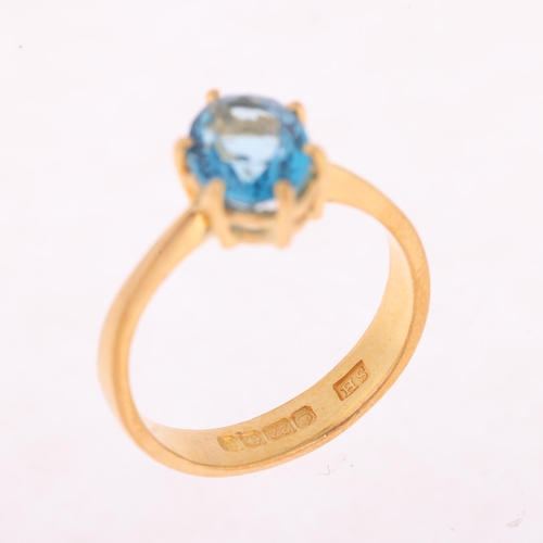 1173 - A 22ct gold single stone blue topaz ring, maker SH, Birmingham 1939, claw set with oval mixed-cut to... 