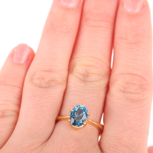 1173 - A 22ct gold single stone blue topaz ring, maker SH, Birmingham 1939, claw set with oval mixed-cut to... 