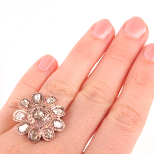 1180 - An Indian Polki diamond flowerhead cluster ring, unmarked mount tests as 14ct rose gold and base met... 