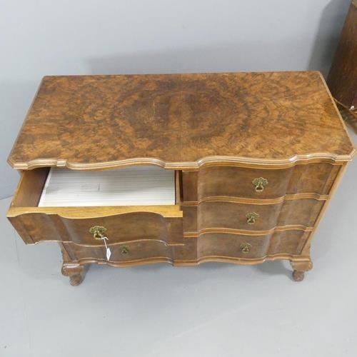 2101 - An early 20th century burr walnut veneered chest of three long drawers, raised on cabriole legs with... 