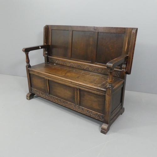 2106 - An early 20th century panelled oak monk's bench with applied carved decoration. As table - 130x72x47... 