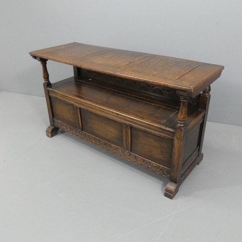 2106 - An early 20th century panelled oak monk's bench with applied carved decoration. As table - 130x72x47... 