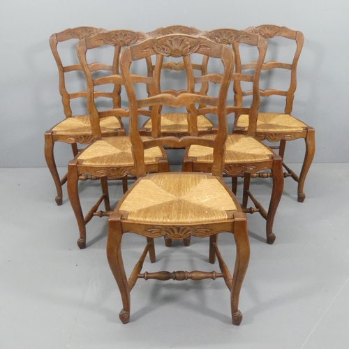 2108 - A set of six French oak rush-seated ladder-back dining chairs.