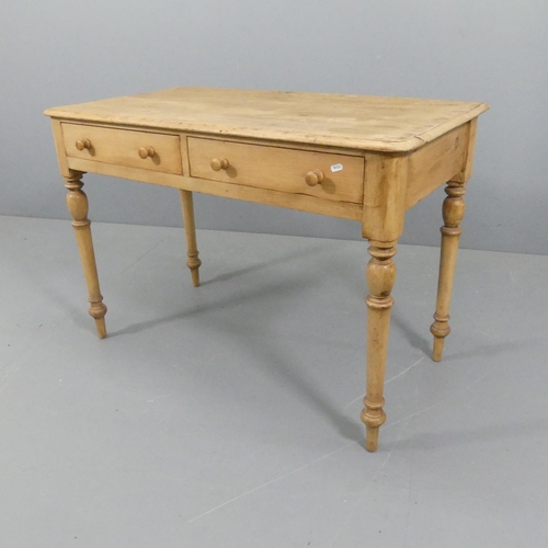 2115 - A vintage pine writing table, with two frieze drawers and raised on turned legs. 107x74x55cm.