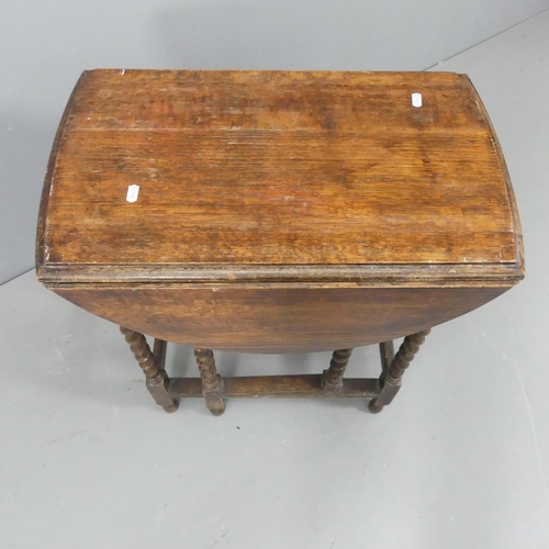 2191 - An early 20th century oak oval gate-leg table with barley twist supports. 60x72x36cm.