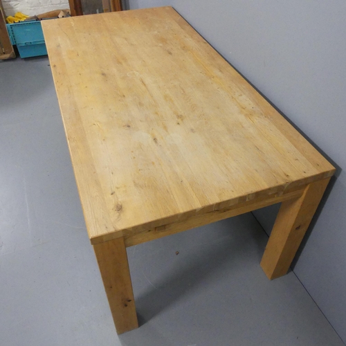 2194 - A modern light oak dining table. 180x75x90cm.