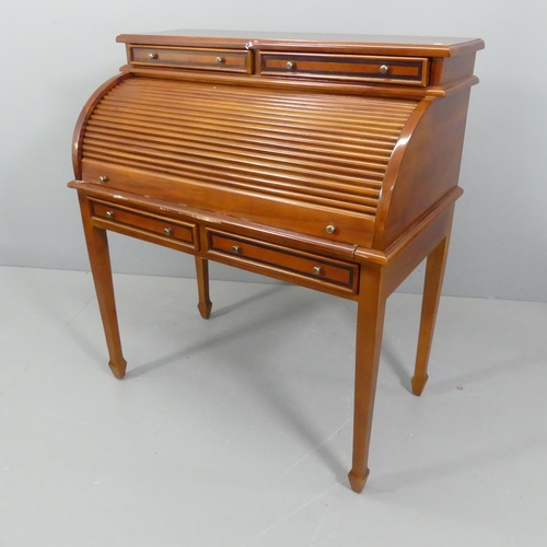 2196 - A reproduction mahogany roll-top bureau, with fitted interior, four drawers and raised on square tap... 