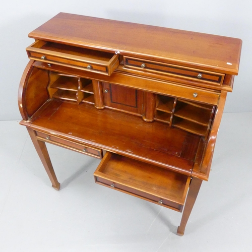 2196 - A reproduction mahogany roll-top bureau, with fitted interior, four drawers and raised on square tap... 