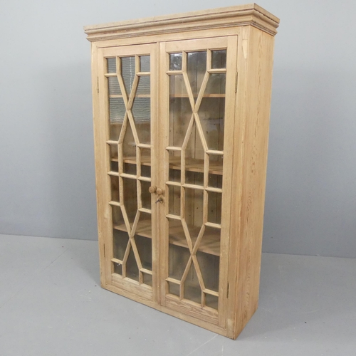 2208 - A Georgian style pitch pine bookcase, with two lattice glazed doors and three adjustable shelves. 92... 