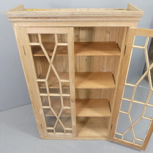 2208 - A Georgian style pitch pine bookcase, with two lattice glazed doors and three adjustable shelves. 92... 