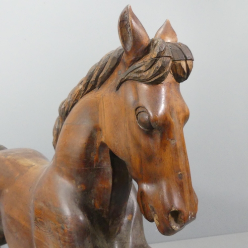 2099 - TREVOR WIFFEN - A large craftsman-made pine rocking horse, with carved mane and tail. Overall 187x12... 