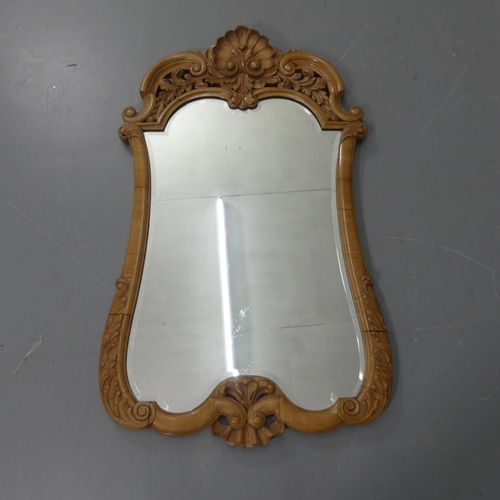 2273 - A French walnut wall mirror, with carved and pierced decoration. 71x116cm.