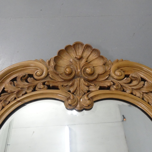 2273 - A French walnut wall mirror, with carved and pierced decoration. 71x116cm.