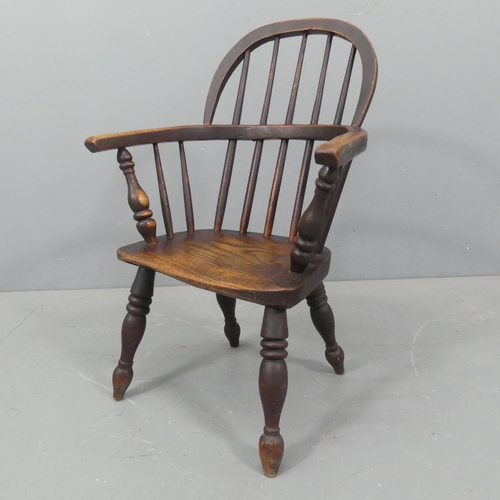 2274 - A child's elm-seated Windsor comb-back chair. Height 74cm.