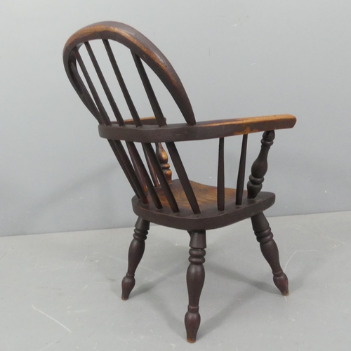 2274 - A child's elm-seated Windsor comb-back chair. Height 74cm.