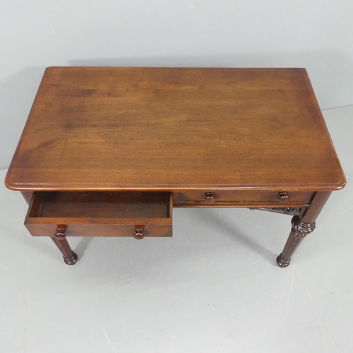 2223 - Heal & Son - a Victorian mahogany writing table, with two frieze drawers and carved and pierced deco... 