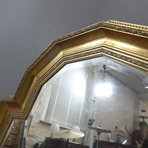 2271 - An Art Deco style gilt painted resin framed wall mirror of stepped design. 114x85cm.