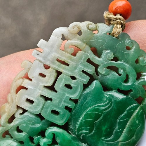 1142 - A Chinese carved jade 'Double Happiness' amulet pendant, carved and pierced depicting peach and blos... 