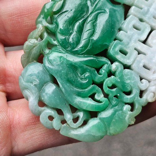 1142 - A Chinese carved jade 'Double Happiness' amulet pendant, carved and pierced depicting peach and blos... 