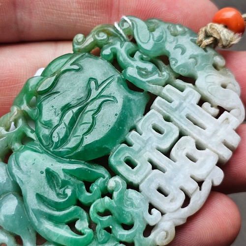 1142 - A Chinese carved jade 'Double Happiness' amulet pendant, carved and pierced depicting peach and blos... 