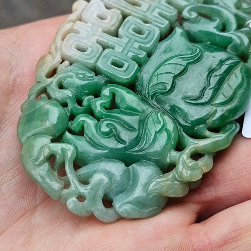 1142 - A Chinese carved jade 'Double Happiness' amulet pendant, carved and pierced depicting peach and blos... 