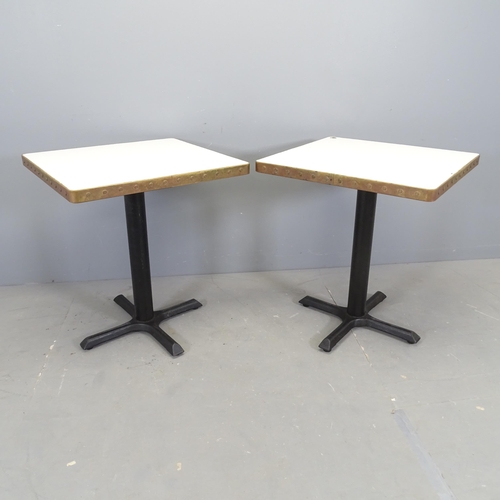 2500 - Seven  modern cafe tables, with laminated top surrounded by copper band and mounted on cast iron fra... 