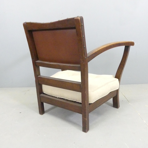 2501 - An Art Deco oak low armchair, with studded brown leather upholstered back and drop-in cushion.