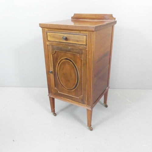 2554 - A 1930s mahogany bedside cabinet, with raised back and inlaid decoration. 41x82x41cm.