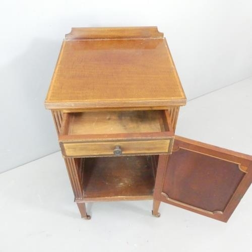 2554 - A 1930s mahogany bedside cabinet, with raised back and inlaid decoration. 41x82x41cm.