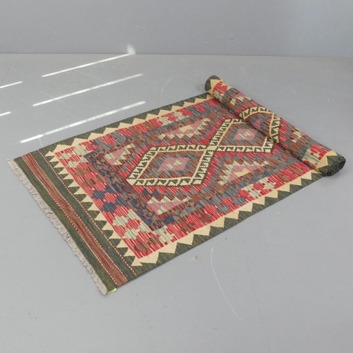 2276 - A red and green-ground Kilim runner. 300x90cm.